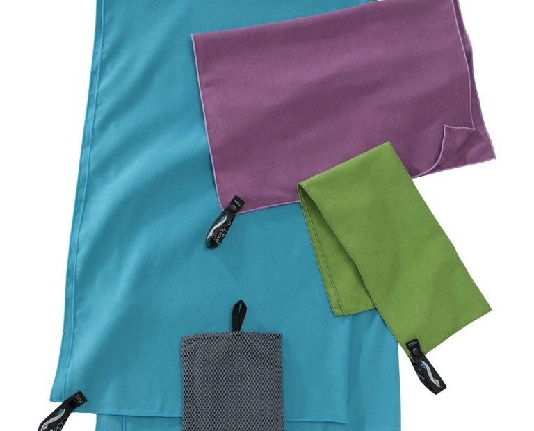 flatlay of 4 different colour towles on a white background, the largest is blue and there are grey, green and purple travel towels folder on top