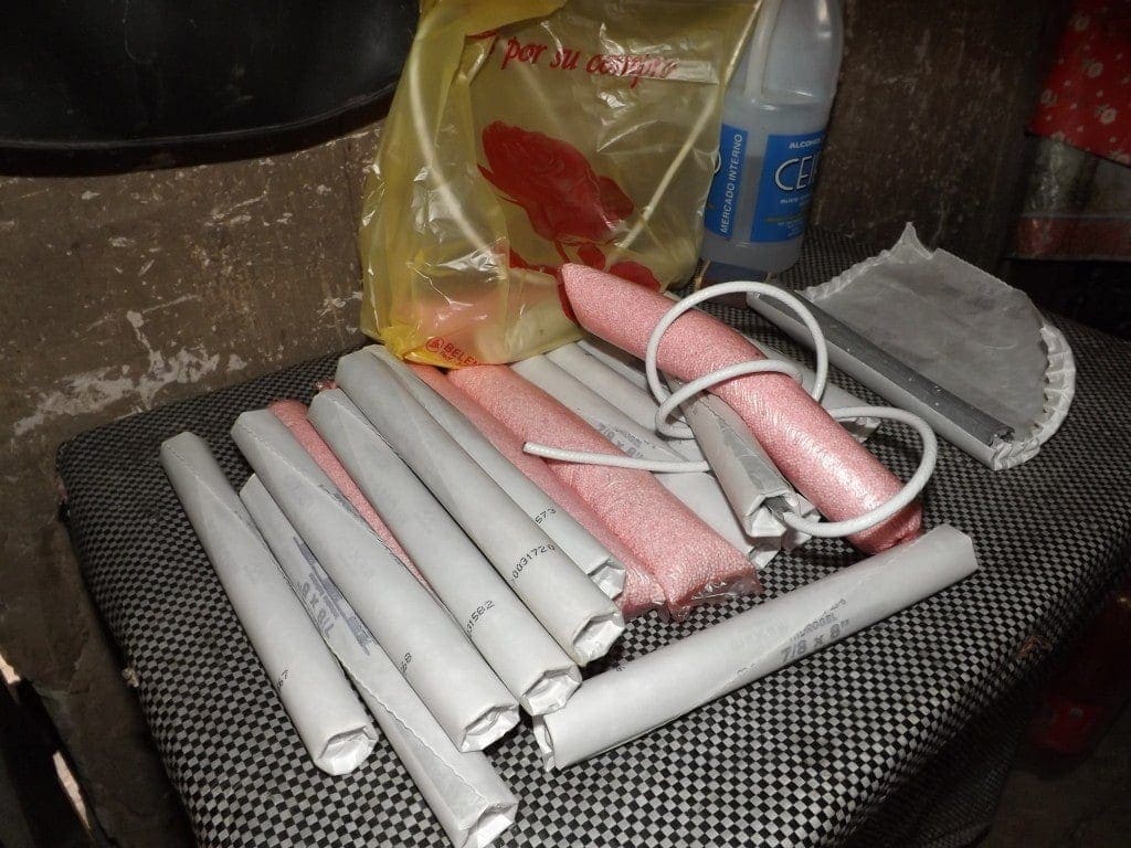 close up of several sticks of dynamite wrapped in paper on the back seat of a car