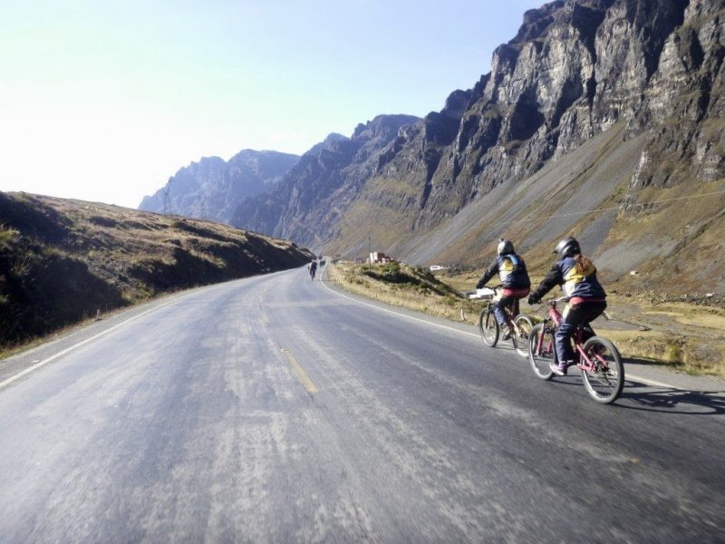 mountain bikers on a tarmac road in Bolivia