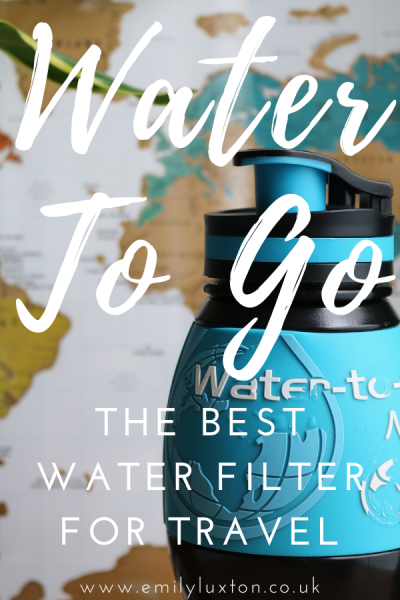 "Water to Go The Best Water Filter for Travel" written in white text on top of a photo of a black water bottle with a map behind.