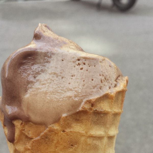 close up of a chocolate ice cream on a waffle cone