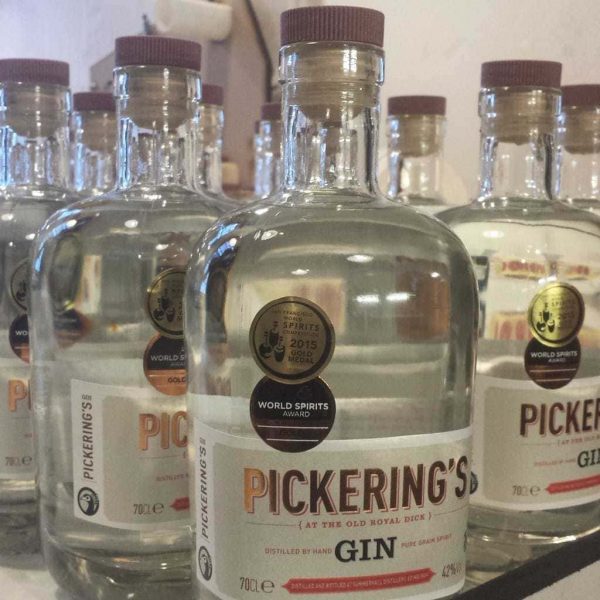 close up of several glass bottles labelled Pickering's Gin, with circular gold stickers labelling a spirits award