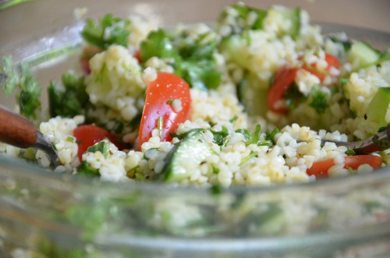 close up of a tabbouleh salad with bulgar, parsley, and tomatoes in a glass bowl - what to eat in dubai