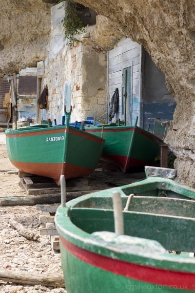 Wooden fishing boats on the coast in Puglia