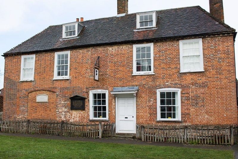 Exterior of Jane Austen's home in Hampshire, a large red brick country cottage with a grey slate roof