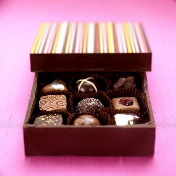 close up of a box of chocolates where the box is also made from chocolate