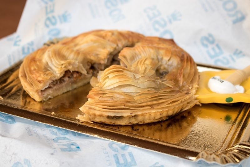 Close up of a pie made from filo pastry on a gold coloured foil plate surrounded by white paper. Reasons to visit Murcia