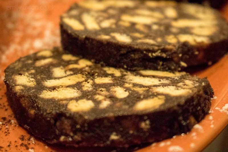 Close up of two slices of chocolate with small pieces of biscuit in on an orange plate. What to eat in Naples