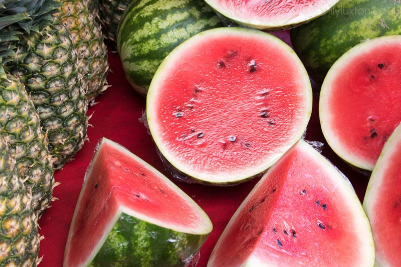 watermelons and pineapples at a market