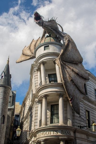 a dragon on top of the tall white building of Gringotts Bank in Universal Studios Orlando