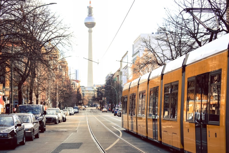 Yellow  public transportation tram passing by the city of Berlin