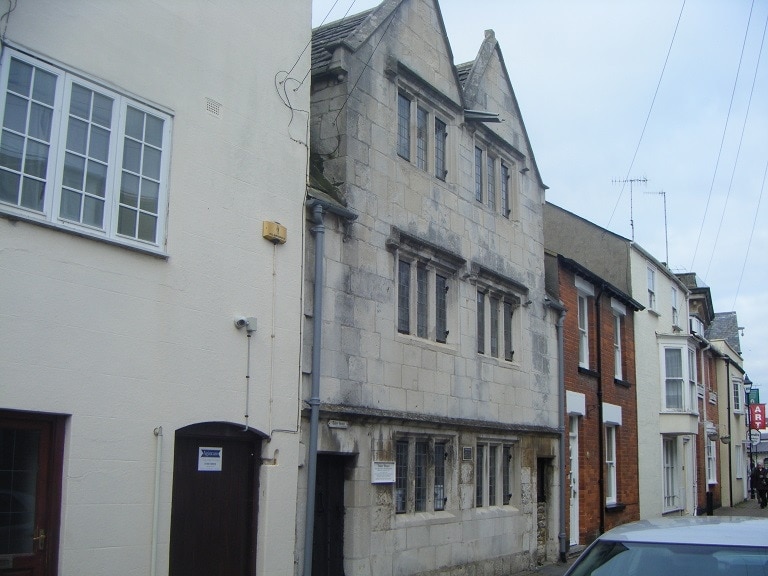 narrow grey stone 3-storey terraced townhouse on a street in weymouth