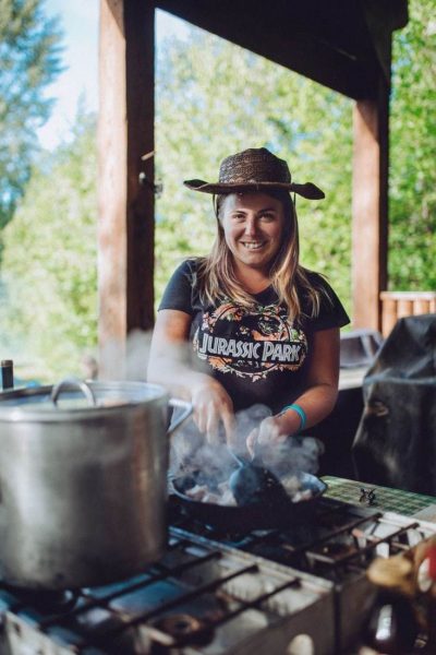 solo traveller cooking at campsite on Trek America