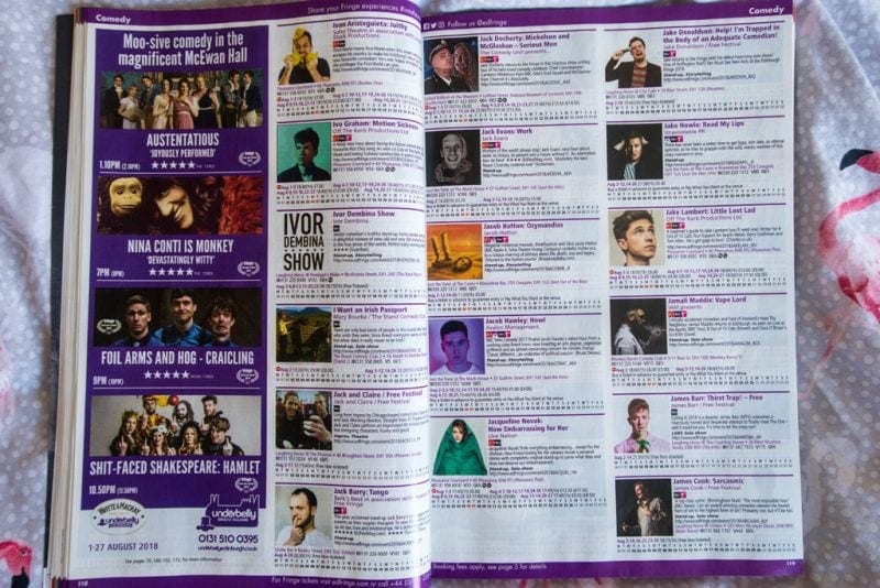 flat lay of an open copy of the Fringe programme with a double page spread showing listings of different shows