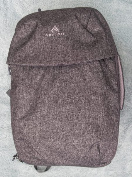 Close up of a grey Arcido Saxon carry on backpack on a plain background