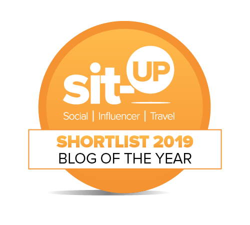 orange circular badge, the text in white reads: Sit-up social influencer travel shortlist 2910 blog of the year"