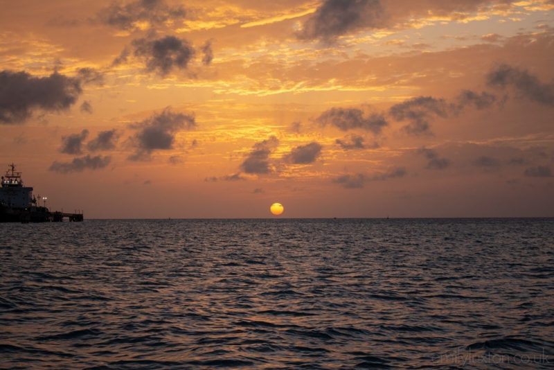 sunset over the ocean viewed from a boat cruise in antigua
