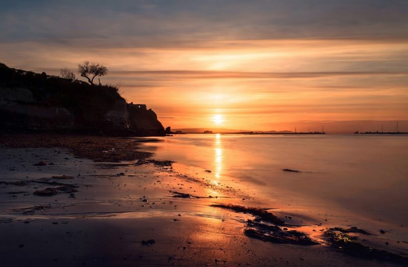 Sunset over Castle Cove Beach in Weymouth