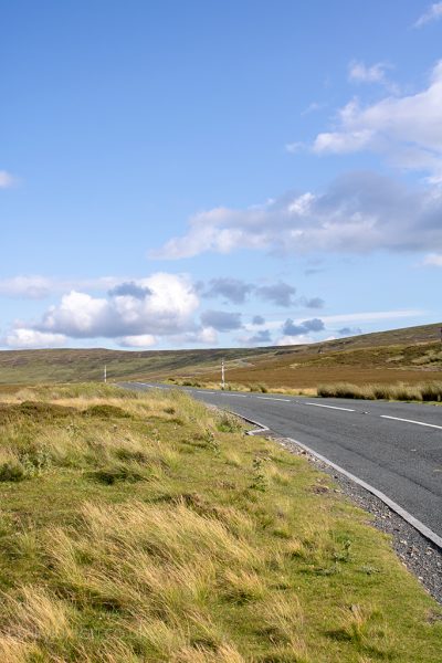 Road in the Durham Dales with grassy moors on either side