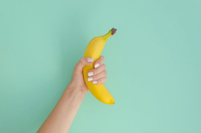 hand holding a banana