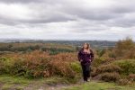 Girl wearing purple parka jacket hiking in the South Downs