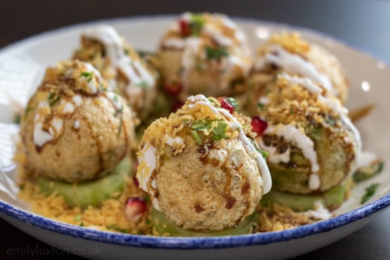 Dahi Chat - crispy balls topped with yoghurt and pomegranate seeds