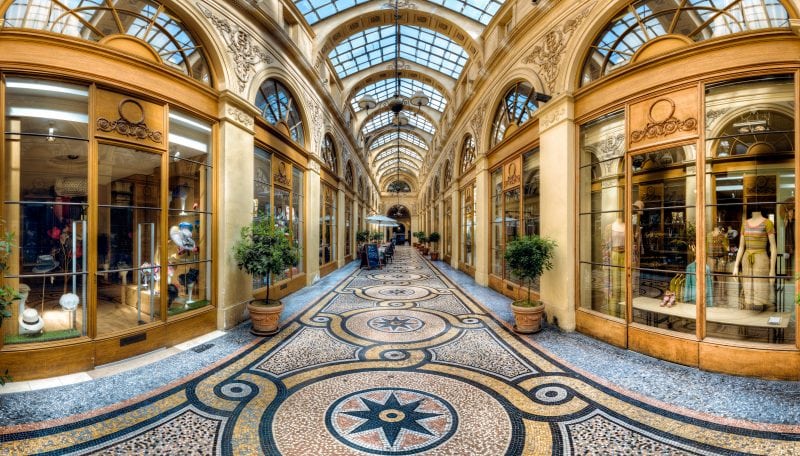 interior of an empty shopping centre in Paris France with mosaic floor and glass roof