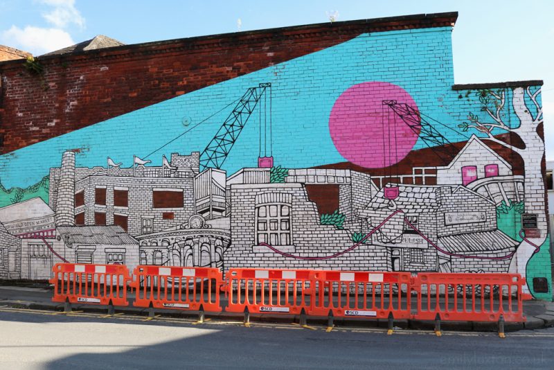 Large street art mural of a city scape painted on the side of a building in Kelham Island Sheffield