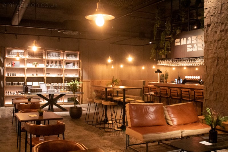 cosy interior of a bar and restaurant with a sign that says Smakk Bar in the background