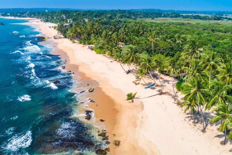 aerial shot of a tropical sandy beach lined with palm trees - 2 weeks sri lanka itinerary