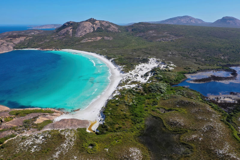 looking down at a peninsula with a white sandy beach and a mountain in the background. working holiday adelaide. 