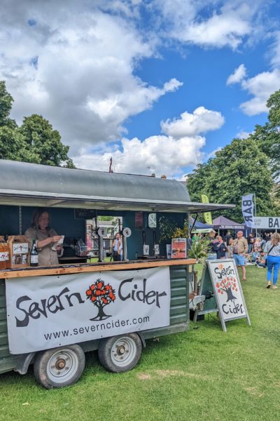 a food stall selling Severn Cider at a festival in a park in Cheltenham