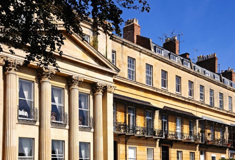 esterior of a row of beige coloured recengy houses - things to do in cheltenham and gloucester