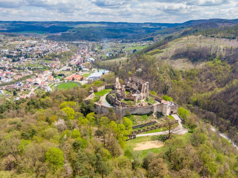 Aerial drone panorama view of medieval castle Boskovice. Ruin of ancient stronghold placed at hill in South Moravia region, Czech Republic. Summer day with blue sky.