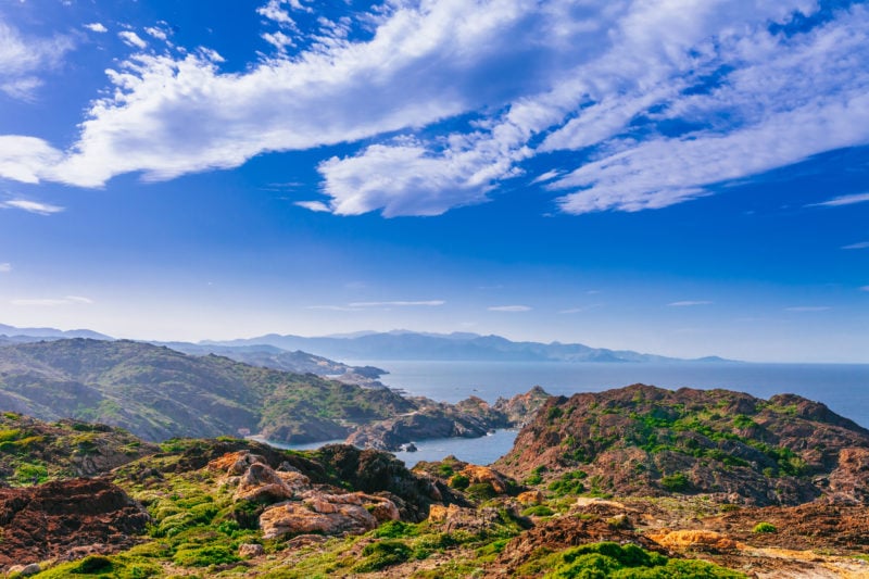 Sea landscape with Cap de Creus, natural park. Eastern point of Spain, Girona province, Catalonia. Famous tourist destination in Costa Brava. Sunny summer day with blue sky and clouds