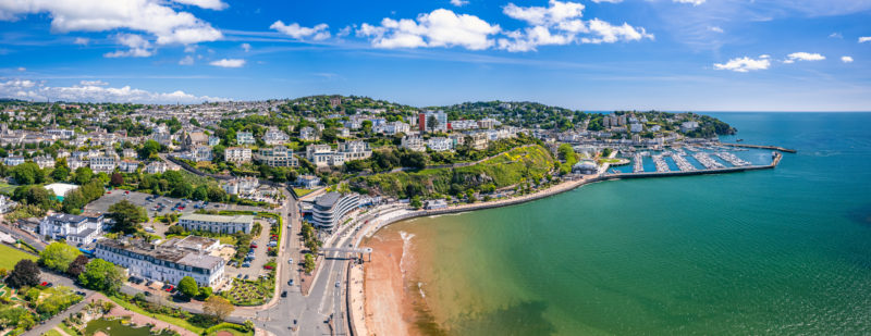 Panorama over English Riviera and Torquay from a drone on a very sunny day with turquoise sea