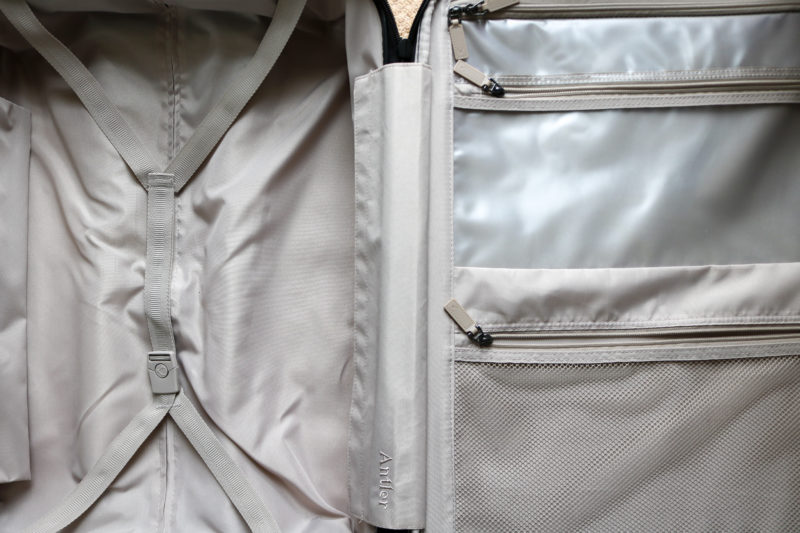 inside of a suitcase with grey trim and a fabric zipped door on the right side with two pockets. Antler Clifton Review