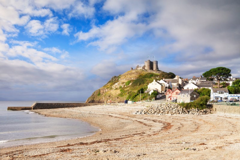 The town and castle of Criccieth, North Wales, on a bright summer day with clearing weather.