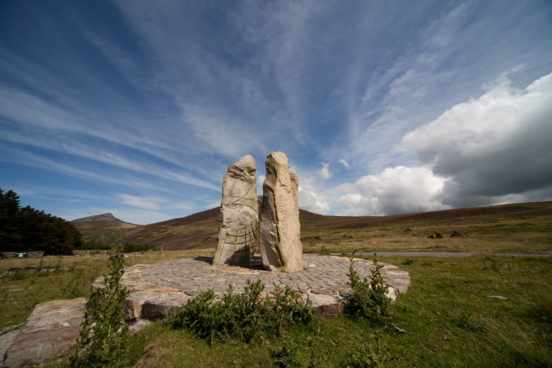 carved stone monoliths on a stone circle Nant Gwrtheyrn a welsh heritage centre down on the Llyn Peninsula coastline north wales