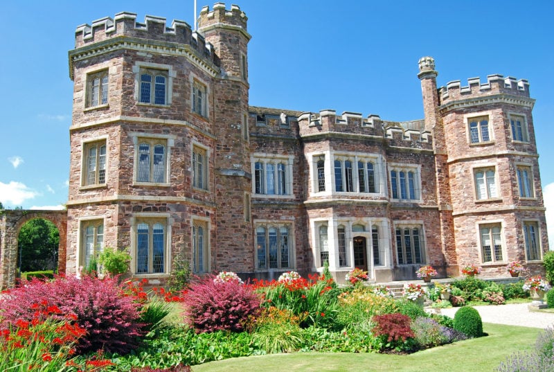 A Beautiful 16th Century English Manor House built from rose coloured bricks with two turrets near Plymouth in Devon