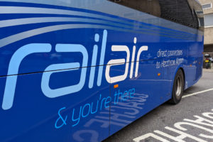 side of a blue bus printed with the words "railair & you're there direct connections to heathrow airport".
