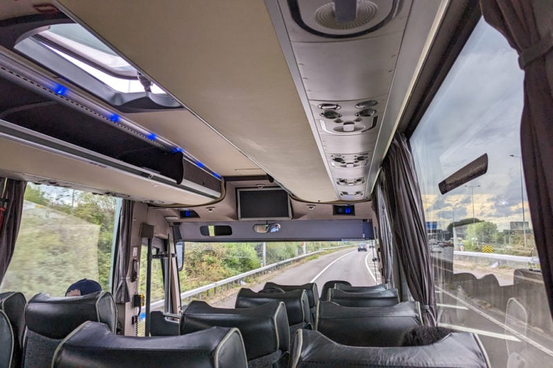 interior of a bus on a motorway looking down towards the windscreen 