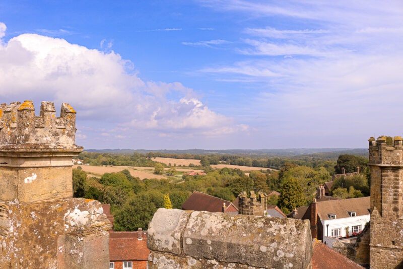 view of Sussex countryside from the roof of a stone tower on a sunny day. Things to do in 1066 Country East Sussex England. 