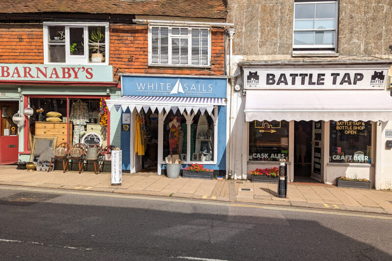 three shops on Battle High Street - Barnaby's, White Sails, and Battle Tap. Top things to do in and near Battle, East Sussex