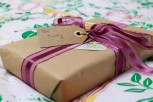 close up of a gift wrapped in brown paper with a pink ribbon