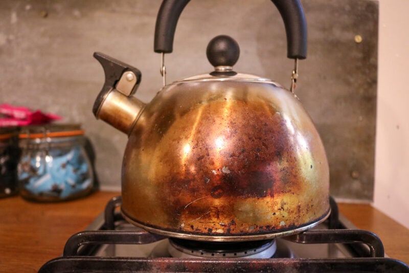 close up of an old fashioned copper kettle on a hob