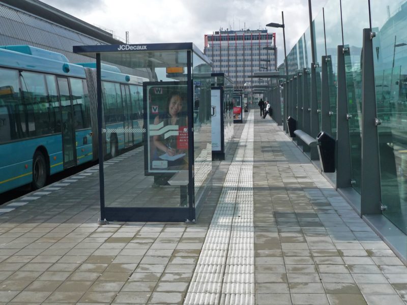 A look through view in the newly built bus station with reflecting glass walls and windows - behind Central Station