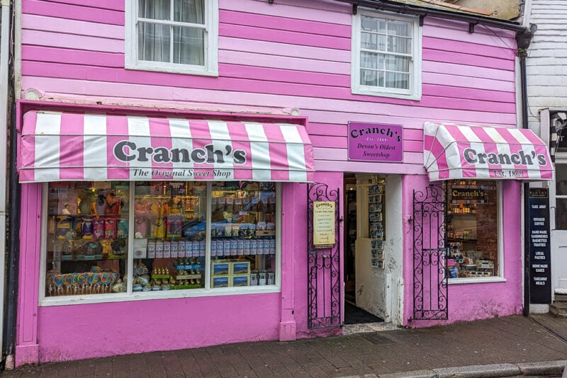 shop with a bright pink stripey fexterior and pink and white striped awning above the window that says Cranch's