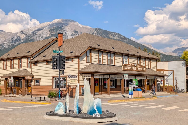 Canmore Hotel with a wood pannelled facade and a mountain behind