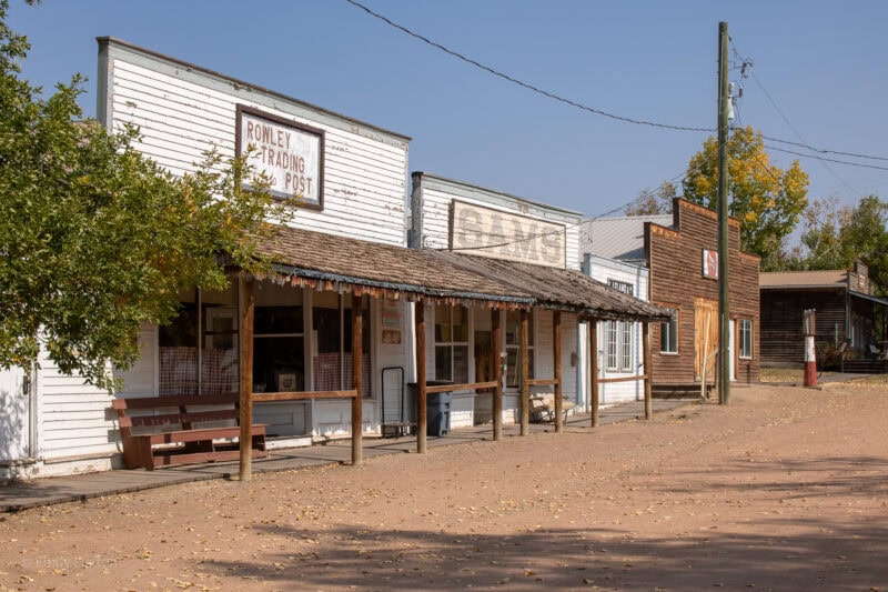 Street in Rowley Alberta with an old fashioned trading post and saloon with white wood-pannelled facads